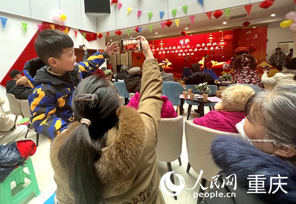 小朋友用手機記錄著歡樂的時刻。人民網(wǎng) 胡虹攝