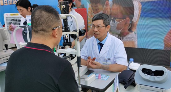 桂君民為現(xiàn)場市民義診。重慶愛爾眼科醫(yī)院總院供圖