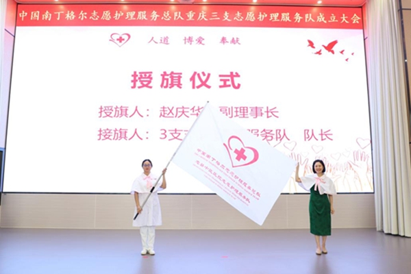 中國南丁格爾志愿護理服務(wù)總隊副理事長趙慶華（右）為服務(wù)隊授旗。李道國攝