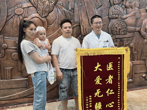 蔡忠?guī)е迌?，為羅醫(yī)生送來(lái)錦旗。朱雋攝