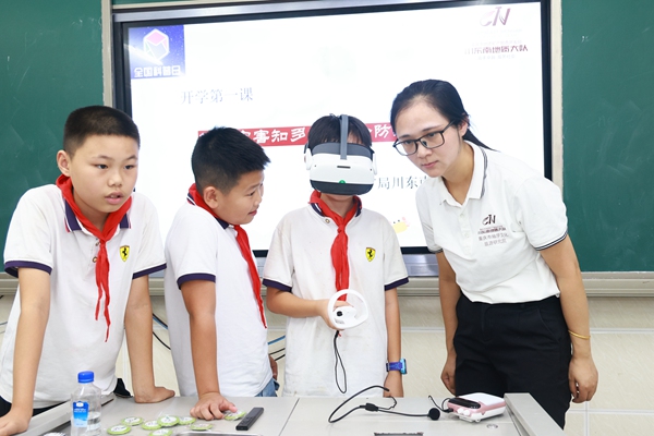 《別開生面的開學(xué)第一課》。9月18日，重慶市規(guī)劃和自然資源局地災(zāi)防治科普宣傳隊、川東南地質(zhì)大隊科普員走進(jìn)渝北區(qū)大盛學(xué)校，為該校五年級、六年級的同學(xué)們帶來了一堂別開生面的地質(zhì)災(zāi)害防治科普“開學(xué)第一課”。圖為科普員艾大利（右）指導(dǎo)同學(xué)們利用VR設(shè)備體驗地災(zāi)發(fā)生場景。曾英豪攝