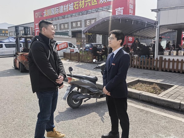 重慶農(nóng)商行沙坪壩支行客戶經(jīng)理李林坤（右）與重慶國際物流樞紐園區(qū)建設有限責任公司大川項目負責人張博（左）在大川國際建材城現(xiàn)場考察項目。重慶農(nóng)商行供圖