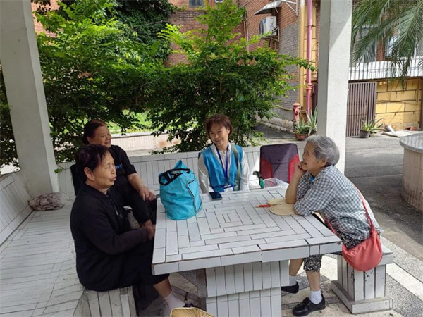 網(wǎng)格員李春梅宣傳相關(guān)工作政策。受訪者供圖