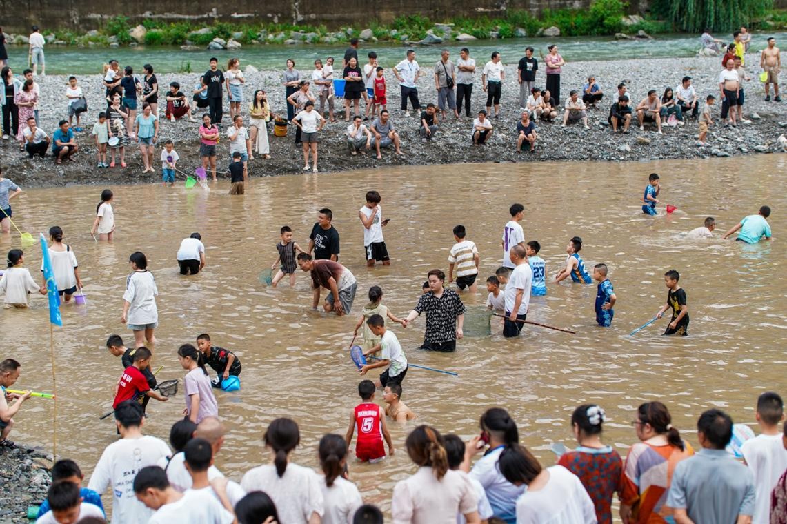 游客正在淺灘參與捉魚等趣味活動。高觀鎮(zhèn)供圖