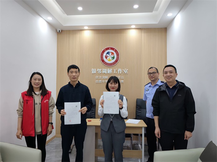 社區(qū)民警、網(wǎng)格員成功調(diào)解謝先生與李女士矛盾糾紛，雙方握手言和。通訊員 王軒 攝