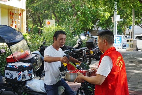 社區(qū)志愿服務(wù)隊(duì)為新就業(yè)群體送清涼物資。龍山街道供圖