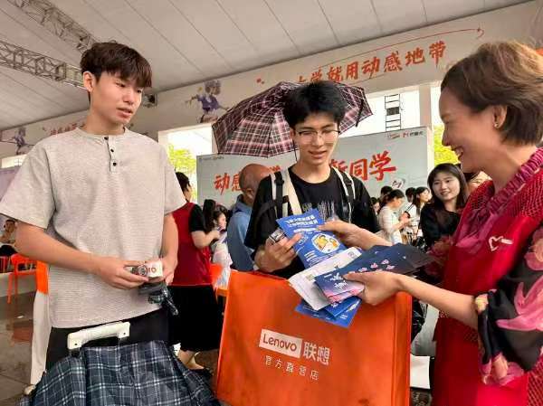 志愿者向新生發(fā)放反詐宣傳資料。主辦方供圖